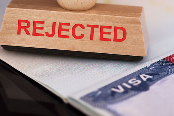 UK visitor visa refusal letter with a stamp reading “Refused”