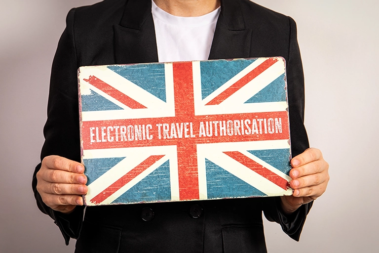 Traveller applying online for a UK Electronic Travel Authorisation (ETA) before flying in 2025